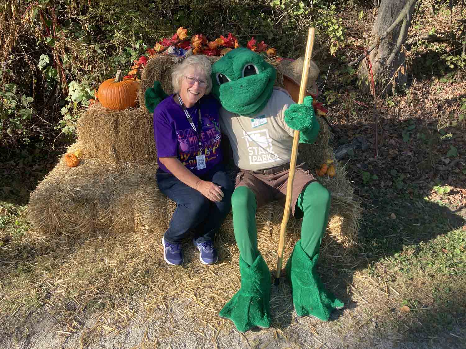 FeLeap Mascot on hay bales with person